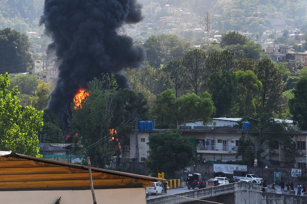 Smoke billows after an army MI-17 helicopter crashed due to a technical fault, in Muzaffarabad, capital of Pakistan-administered Kashmir, Wednesday, June 10, 2026. (AP Photo/M.D. Mughal)