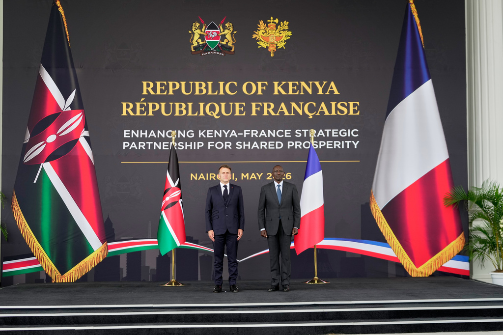 French President Emmanuel Macron, left, and Kenyan President William Ruto stand during the national anthems at State House in Nairobi, Kenya, Sunday, May 10, 2026. (AP Photo/Brian Inganga)