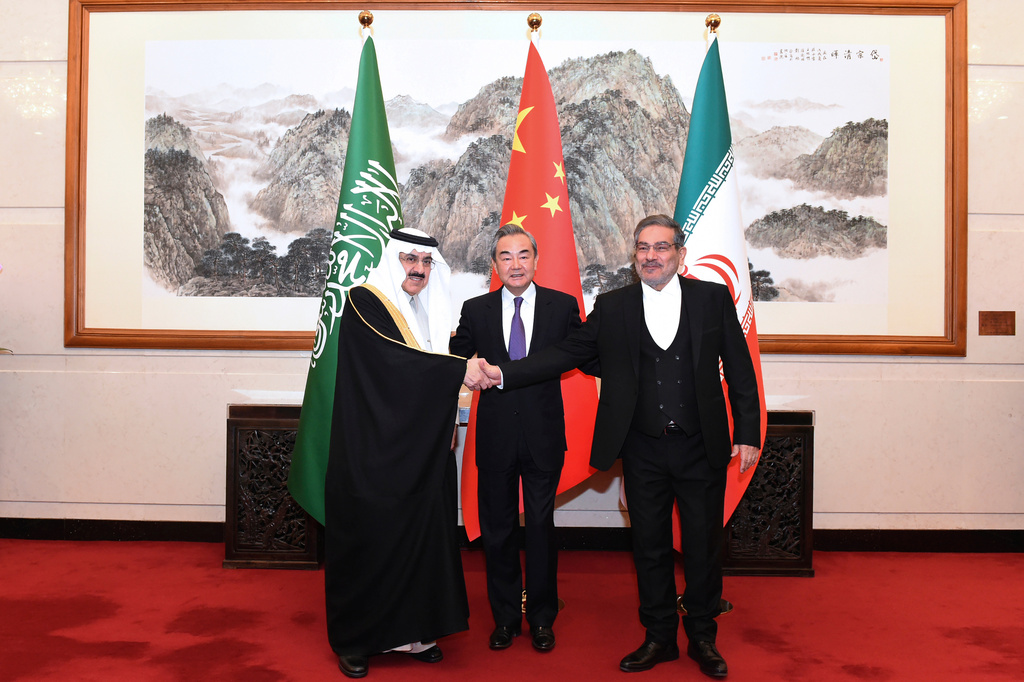 FILE - In this photo released by Xinhua News Agency, Ali Shamkhani, then secretary of Iran's Supreme National Security Council, right, shakes hands with Saudi national security adviser Musaad bin Mohammed al-Aiban, left, as Wang Yi, China's most senior diplomat, looks on for a photo during a closed meeting held in Beijing, on March 11, 2023. (Luo Xiaoguang/Xinhua via AP, File)