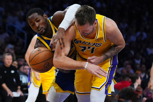 Golden State Warriors guard Jonathan Kuminga, left, works for a round against Los Angeles Lakers' Luka Dončić (77) during the first half of an NBA basketball game Tuesday, Oct. 21, 2025, in Los Angeles. (AP Photo/Ethan Swope) Golden State Warriors guard Jonathan Kuminga, left, works for a round against Los Angeles Lakers' Luka Dončić (77) during the first half of an NBA basketball game Tuesday, Oct. 21, 2025, in Los Angeles. (AP Photo/Ethan Swope)