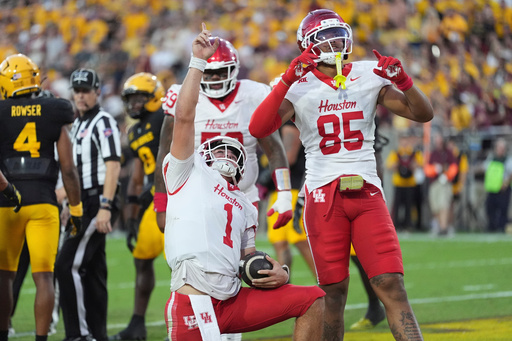 Houston quarterback Conner Weigman (1) celebrates his touchdown against Arizona State with Houston tight end Traville Frederick Jr. (85) during the first half of an NCAA college football game Saturday, Oct. 25, 2025, in Tempe, Ariz. (AP Photo/Ross D. Franklin) Houston quarterback Conner Weigman (1) celebrates his touchdown against Arizona State with Houston tight end Traville Frederick Jr. (85) during the first half of an NCAA college football game Saturday, Oct. 25, 2025, in Tempe, Ariz. (AP Photo/Ross D. Franklin)