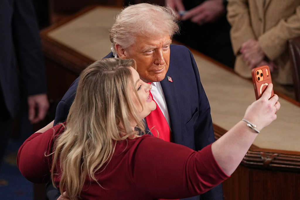 President Donald Trump takes a photo with Rep. Kat Cammack, R-Fla., after delivering the State of the Union address to a joint session of Congress in the House chamber at the U.S. Capitol in Washington, Tuesday, Feb. 24, 2026. (AP Photo/Matt Rourke)