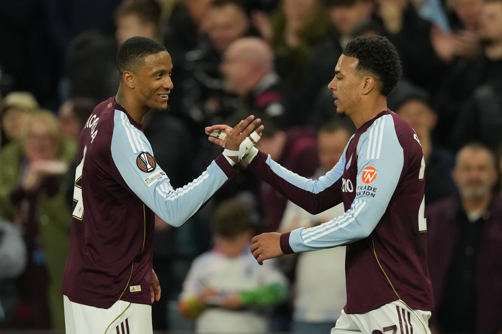 Aston Villa's Morgan Rogers, right, celebrates after scores his side's third goal during the Europa League quarterfinal second leg soccer match between Aston Villa and Bologna, in Birmingham, England, Thursday, April 16, 2026. (AP Photo/Dave Shopland)