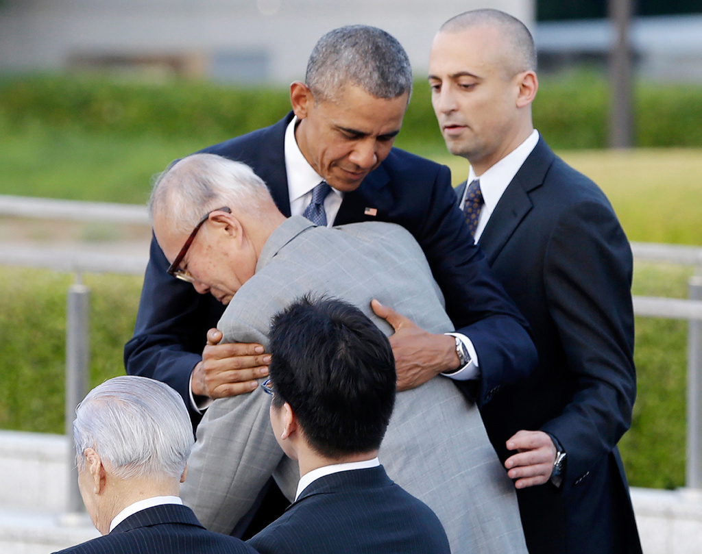 FILE - U.S. President Barack Obama hugs Shigeaki Mori, an atomic bomb survivor; creator of the memorial for American WWII POWs killed at Hiroshima, during a ceremony at Hiroshima Peace Memorial Park in Hiroshima, western, Japan, May 27, 2016. (AP Photo/Carolyn Kaster)