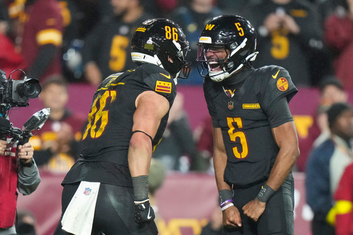 Washington Commanders tight end Zach Ertz (86) and quarterback Jayden Daniels (5) celebrate connecting for a touchdown during the second half of an NFL football game Monday, Oct. 13, 2025, in Landover, Md. (AP Photo/Stephanie Scarbrough) Washington Commanders tight end Zach Ertz (86) and quarterback Jayden Daniels (5) celebrate connecting for a touchdown during the second half of an NFL football game Monday, Oct. 13, 2025, in Landover, Md. (AP Photo/Stephanie Scarbrough)