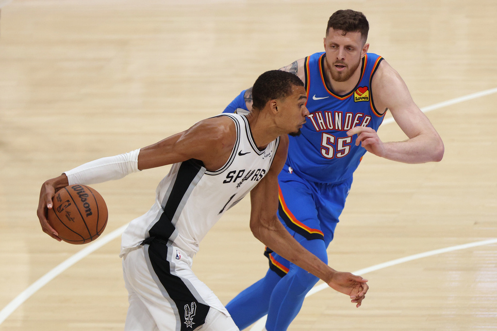 San Antonio Spurs forward Victor Wembanyama (1) controls the ball against Oklahoma City Thunder center Isaiah Hartenstein (55) during the second half of Game 2 in the Western Conference finals NBA basketball playoffs series Wednesday, May 20, 2026, in Oklahoma City. (AP Photo/Nate Billings)