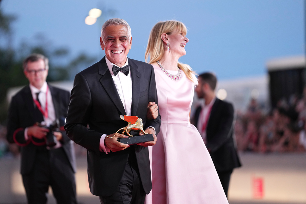 George Clooney, left, recipient of the golden lion for lifetime achievement and Laura Dern pose for photographers during the 83rd edition of the Venice Film Festival in Venice, Italy, on Wednesday, Sept. 2, 2026. (Photo by Scott A Garfitt/Invision/AP)