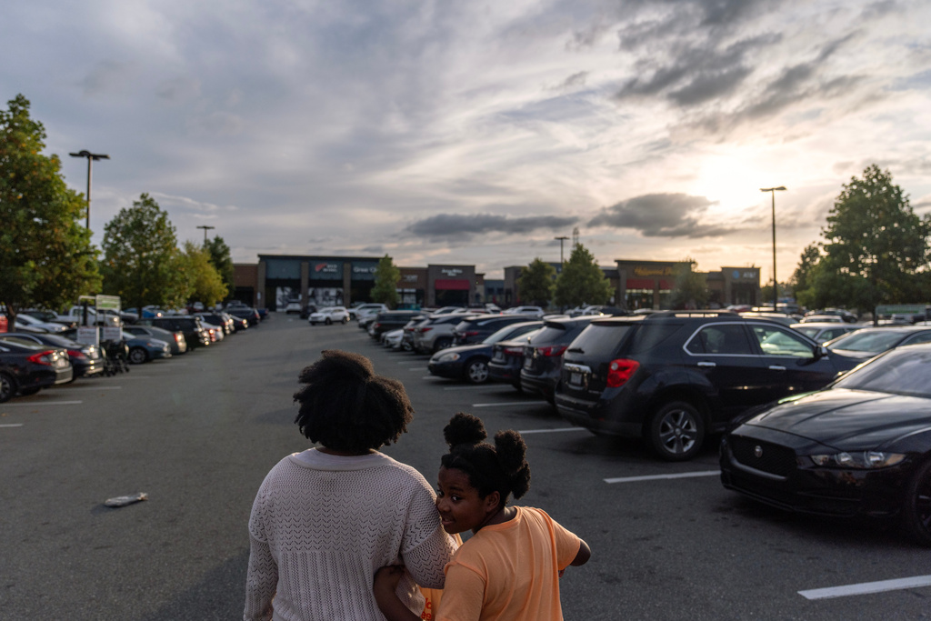 Kiara Alexander, left, who was hospitalized with autoimmune encephalitis, leaves a grocery store with her daughter Kennedi, Friday, Oct. 10, 2025, in Charlotte, N.C. (AP Photo/David Goldman)
