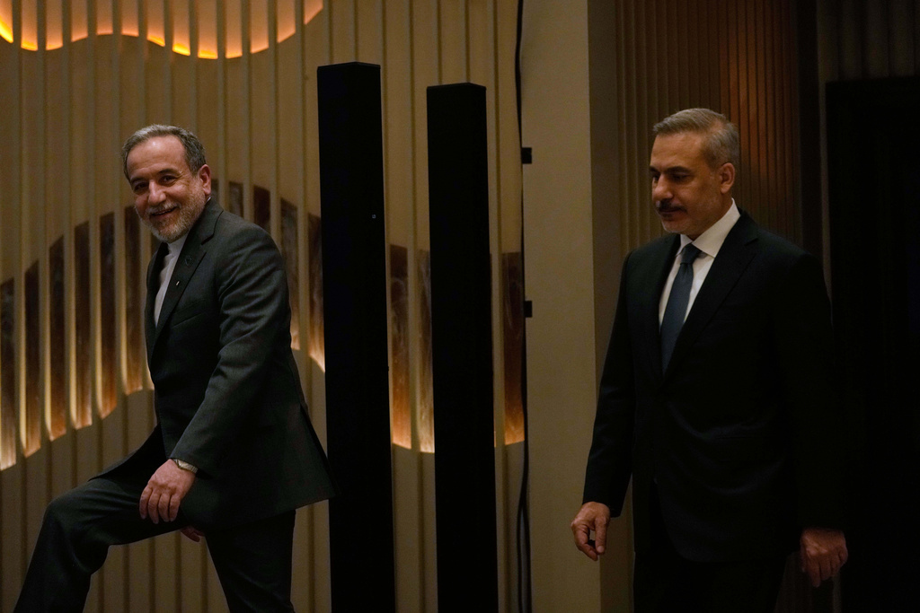 Iranian Foreign Minister Abbas Araghchi, left, smiles as he arrives with his Turkish counterpart Hakan Fidan to a joint press conference in Istanbul, Turkey, Friday, Jan. 30, 2026. (AP Photo/Khalil Hamra)