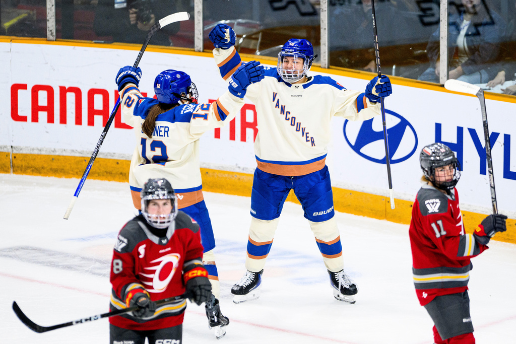 Vancouver Goldeneyes' Sophie Jaques, right, celebrates after her goal against the Ottawa Charge during third-period PWHL hockey game action in Ottawa, Ontario, Friday, Jan. 9, 2026. (Spencer Colby/The Canadian Press via AP)