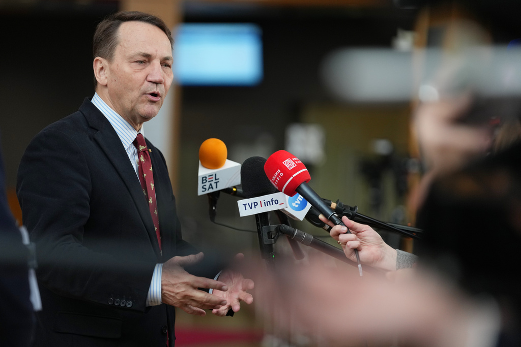 Poland's Foreign Minister Radoslaw Sikorski speaks with the media as he arrives for a meeting of EU foreign ministers at the European Council building in Brussels, Monday, March 16, 2026. (AP Photo/Virginia Mayo)