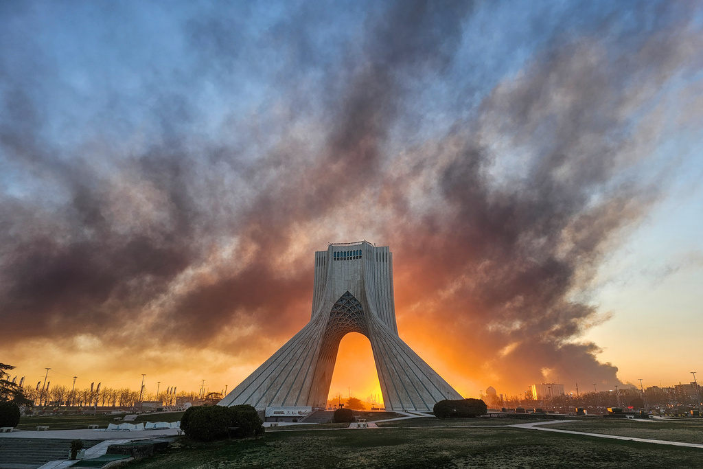Smoke rises up behind Azadi, or freedom tower, following a U.S.-Israeli military strike in Tehran, Iran, Tuesday, March 3, 2026. ((Davoud Ghahrdar/ISNA via AP)