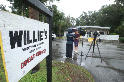 A reporter works outside of Willie's Bar and Grill in St Helena Island, S.C. after a shooting occurred early Sunday, Oct. 12, 2025. (AP Photo/Lewis M. Levine) A reporter works outside of Willie's Bar and Grill in St Helena Island, S.C. after a shooting occurred early Sunday, Oct. 12, 2025. (AP Photo/Lewis M. Levine)