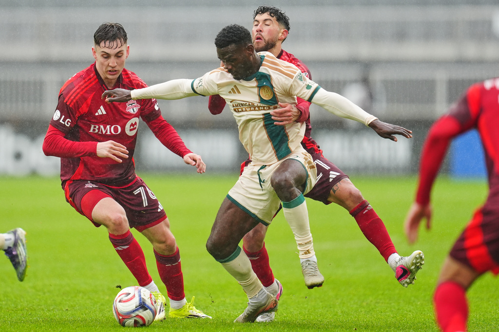 Toronto FC's Lazar Stefanović, left, and Jonathan Osorio, rear, battle for the ball with Atlanta United's Emmanuel Latte Lath (9) during the first half of an MLS soccer game in Toronto, Saturday, April 25, 2026. (Frank Gunn/The Canadian Press via AP)