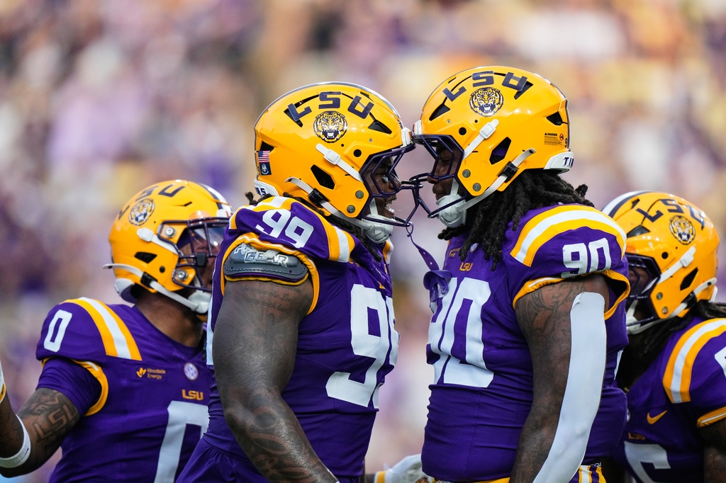 LSU defensive tackle Deuce Geralds (99) celebrates his sack with defensive tackle Stephiylan Green (90) in the first half of an NCAA college football game, Saturday, Sept. 12, 2026 in Baton Rouge, La. (AP Photo/Gerald Herbert)