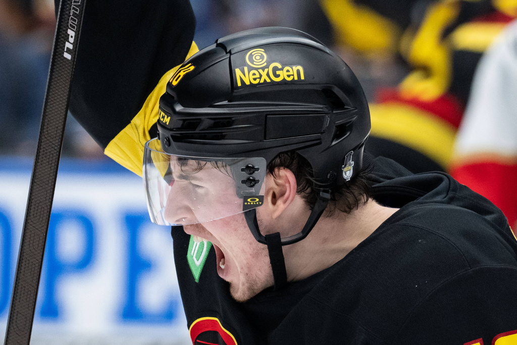 Vancouver Canucks' Drew O'Connor (18) reacts to a goal during the second period of an NHL hockey game against the Florida Panthers in Vancouver, Tuesday, March 17, 2026. (Ethan Cairns/The Canadian Press via AP)