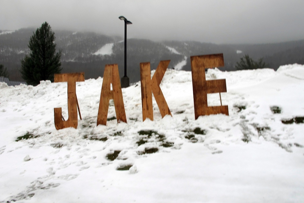 FILE - A wooden sign honoring snowboard pioneer Jake Burton Carpenter sits at the entranceway to a parking lot at Stowe Mountain Resort, Nov. 22, 2019, in Stowe, Vt. (AP Photo/Lisa Rathke, File)