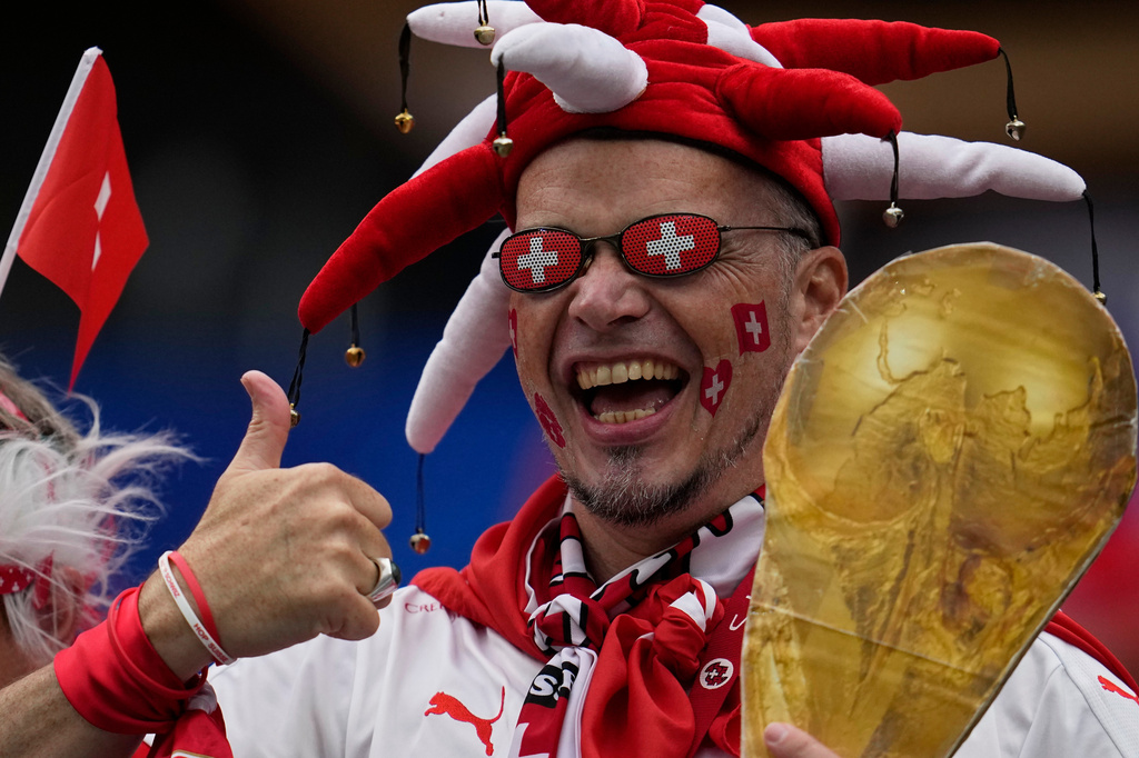 A fan of Switzerland holds a replica of a World Cup trophy ahead the World Cup Group B soccer match between Switzerland and Bosnia in Inglewood, Calif, near Los Angeles, Thursday, June 18, 2026. (AP Photo/Gregory Bull)