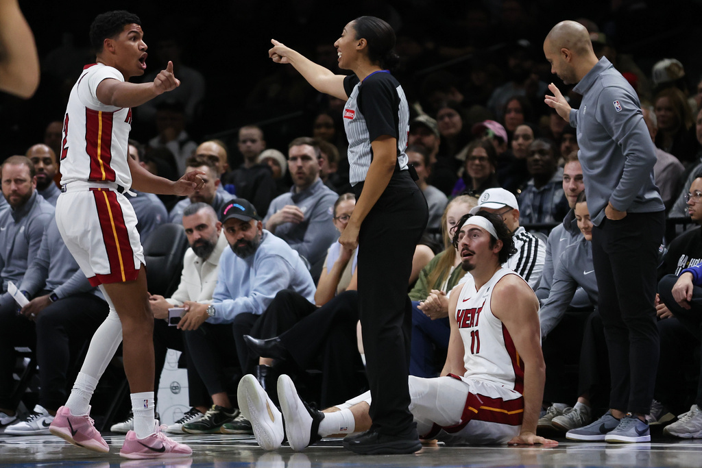 Miami Heat forward Jaime Jaquez Jr. (11) watches after falling as teammate Dru Smith argues with an official during the first half of an NBA basketball game, Thursday, Dec. 18, 2025, in New York. (AP Photo/Heather Khalifa)