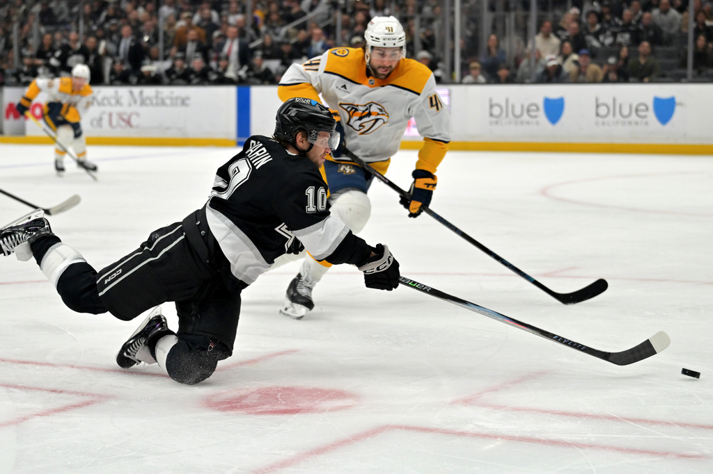 Nashville Predators defenseman Nicolas Hague (41) looks on as Los Angeles Kings left wing Artemi Panarin (10) takes a shot on goal during the second period of an NHL hockey game Thursday, April 2, 2026, in Los Angeles. (AP Photo/Jayne Kamin-Oncea)