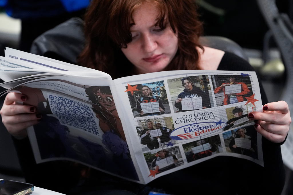 FILE - Columbia College Chicago student Kailey Ryan reads a newspaper in Chicago on Nov. 5, 2024. (AP Photo/Nam Y. Huh, File)