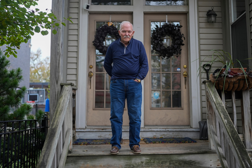 Skip Yates, who witnessed federal immigration agents deploy tear gas on his street in Lakeview in October, stands in front of his home, Wednesday, Nov. 19, 2025, in Chicago. (AP Photo/Erin Hooley)