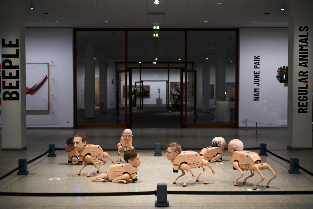 From left: Robots in the likeness of Kim Jong Un, Mark Zuckerberg, Jeff Bezos, Elon Musk, Beeple, Andy Warhol and Pablo Picasso, displayed at the installation titled Regular Animals by the artist Beeple, Mike Winkelmann, at the Neue Nationalgalerie museum in Berlin, Germany, Tuesday, April 28, 2026. (AP Photo/Markus Schreiber)