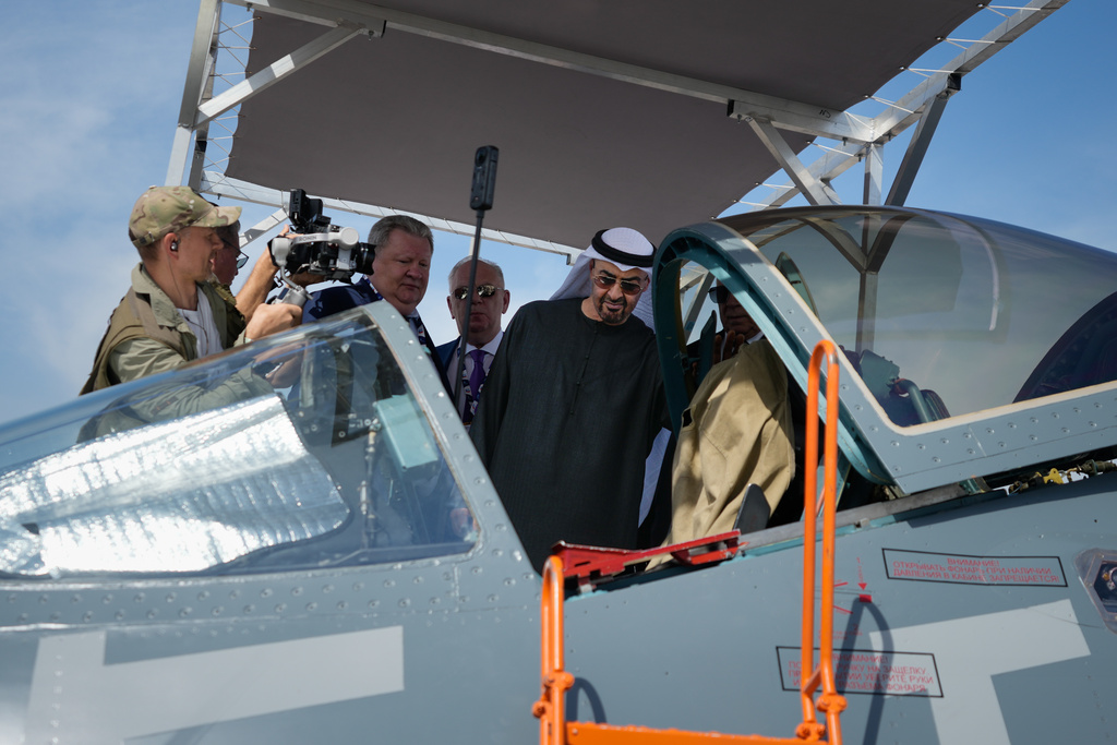 Sheikh Mohammed bin Zayed Al Nahyan, the president of the United Arab Emirates and the ruler of Abu Dhabi, checks the cockpit of Russia's SU57E fighter jet at Russian pavilion during the opening day of the Dubai Air Show, United Arab Emirates, Monday, Nov. 17, 2025. (AP Photo/Altaf Qadri)