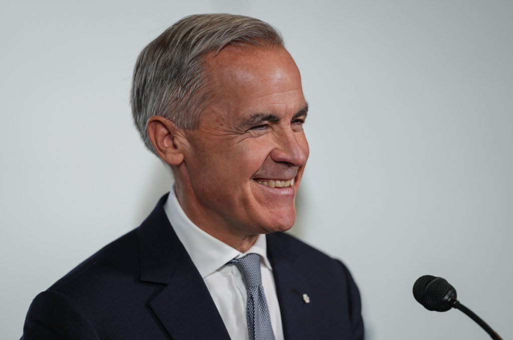Canada Prime Minister Mark Carney laughs when asked if Canada will apologize to the U.S. for the sake of a trade deal, during an announcement about funding for oceans protection, in North Vancouver, British Columbia, Canada, Tuesday, Sept. 29, 2026. (Darryl Dyck/The Canadian Press via AP)