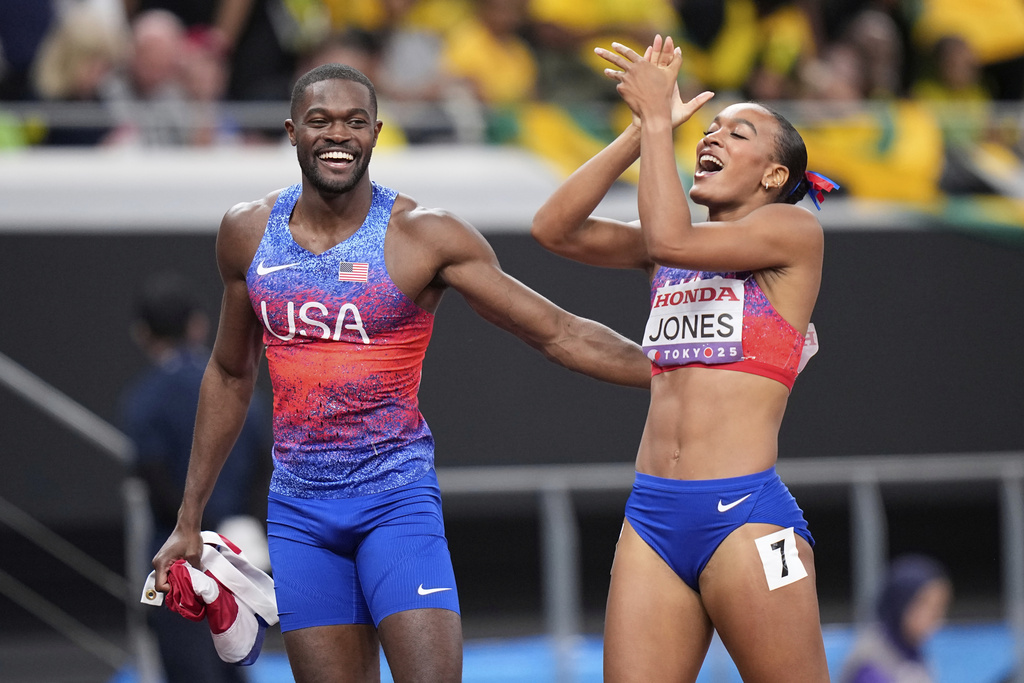 Gold medalist United States' Rai Benjamin of the men's 400 meters hurdles final celebrates with silver medalist United States' Jasmine Jones of women's 400 meters hurdles final at the World Athletics Championships in Tokyo, Friday, Sept. 19, 2025. (AP Photo/Eugene Hoshiko)