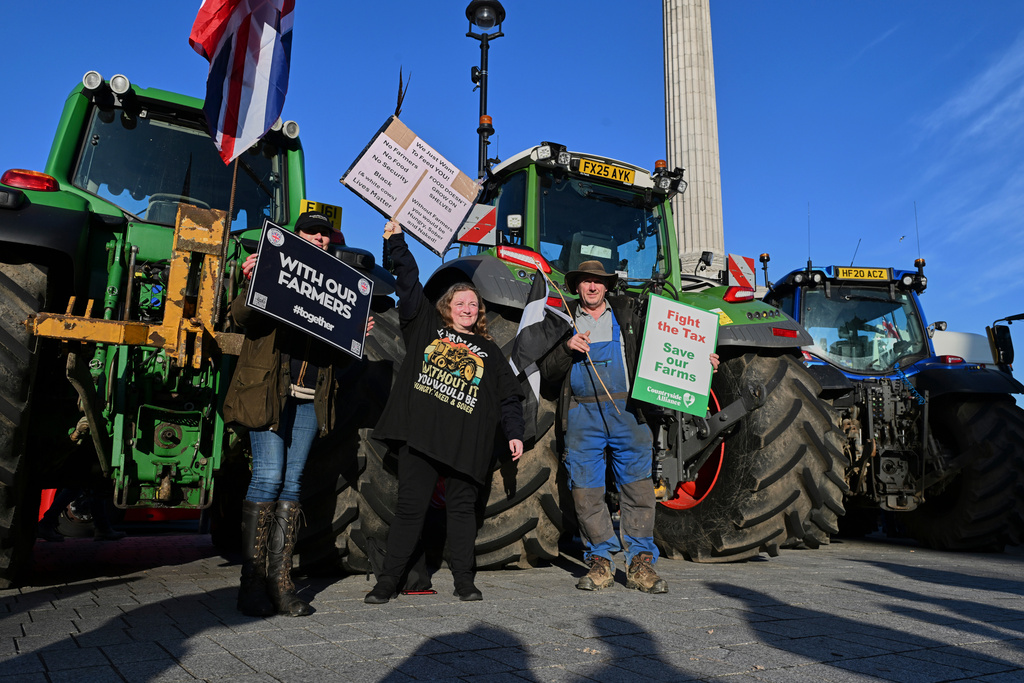 Frames pose with placards demonstrating against inheritance tax in trafalgar Square, ahead of Britain's Chancellor of the Exchequer Rachel Reeves delivering the governments annual spending budget, in London, Wednesday, Nov. 26, 2025. (AP Photo/Thomas Krych)