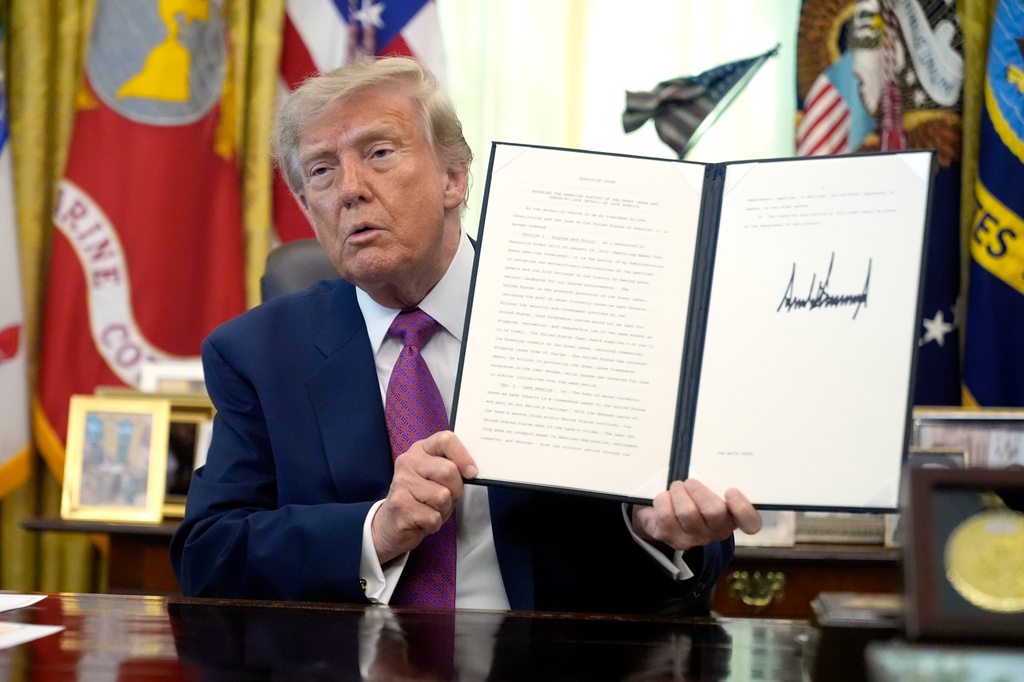 President Donald Trump holds up a signed executive order in the Oval Office of the White House, Thursday, Aug. 27, 2026, in Washington. (AP Photo/Manuel Balce Ceneta)