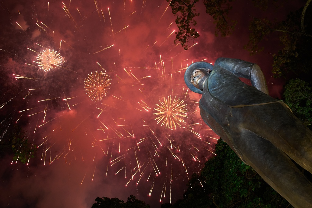 FILE - Fireworks explode above a statue of Jose Gregorio Hernandez who will be canonized by Pope Leo XIV, during an event to celebrate Venezuela's first saint, in Caracas, Oct. 19, 2025. (AP Photo/Ariana Cubillos, File)