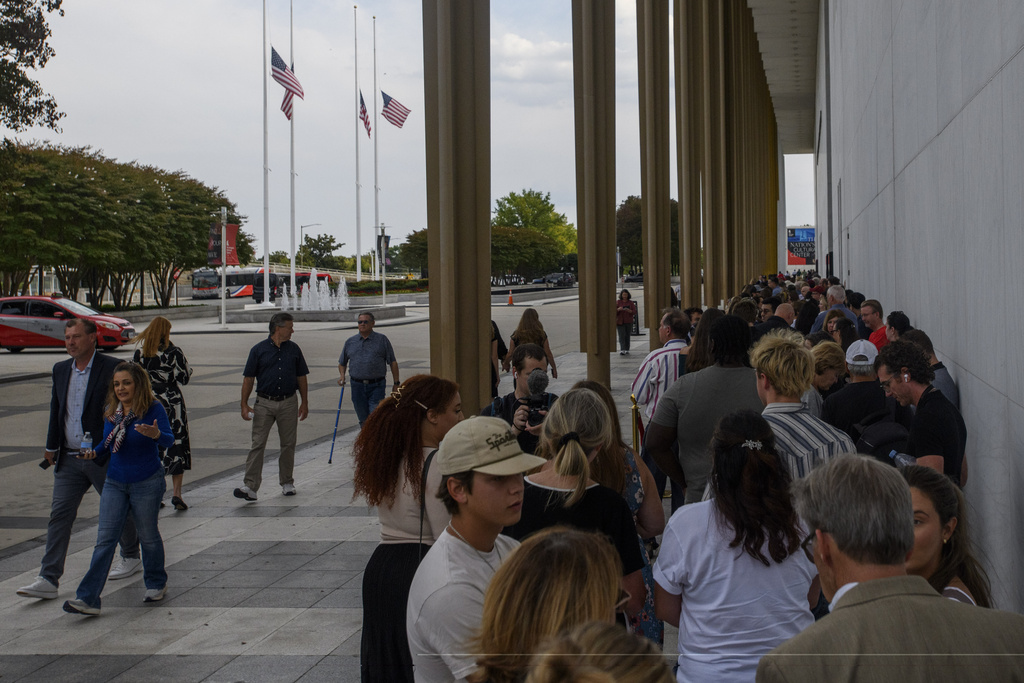People wait in line for a memorial and prayer vigil for Charlie Kirk at the John F. Kennedy Memorial Center for the Performing Arts, Sunday, Sept. 14, 2025, in Washington. (AP Photo/Rod Lamkey, Jr.)
