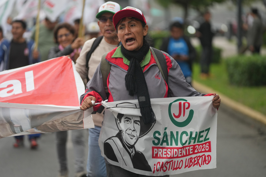 A supporter of presidential candidate Roberto Sanchez of the Together for Peru party march in protest against presidential candidate Keiko Fujimori of the Popular Force party in Lima, Peru, Friday, June 19, 2026. (AP Photo/Miguel Paredes)
