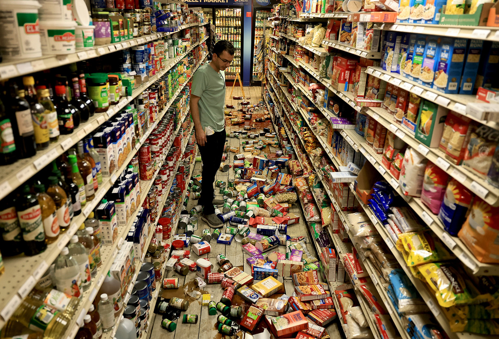 Redwood Valley Market owner Alex Chehada looks at items which fell off the shelves after an earthquake in Redwood Valley, Calif., Wednesday, June 24, 2026. (Kent Porter/The Press Democrat via AP)