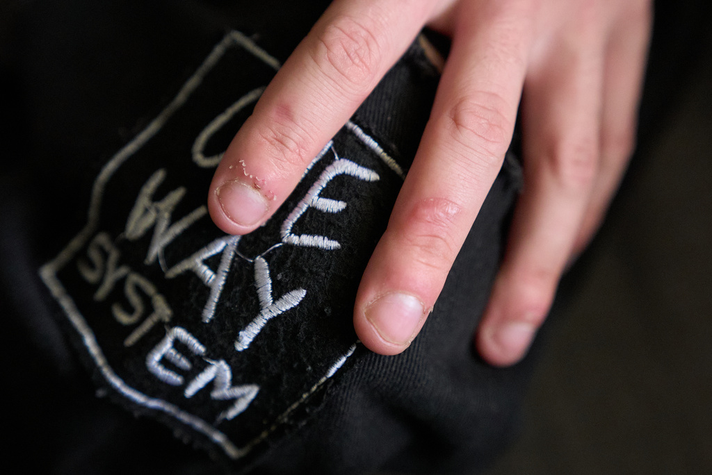 Elijah Button, 21, shows a scar on his middle fingers caused by a knife wound that he was unable to seek medical help for, in St. Cloud, Fla., Thursday, Aug. 13, 2026. (AP Photo/Jacquelyn Martin)