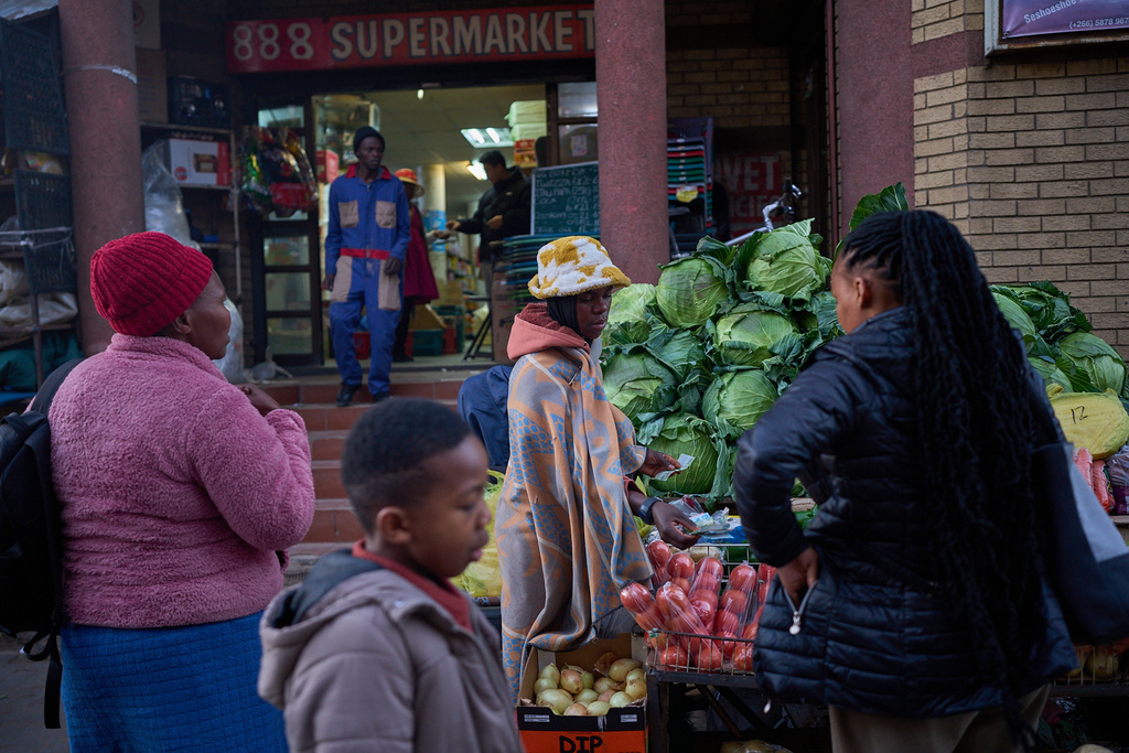FILE - People buy vegetables at a market in Maseru, Lesotho, July 22, 2025. (AP Photo/Bram Janssen, File)
