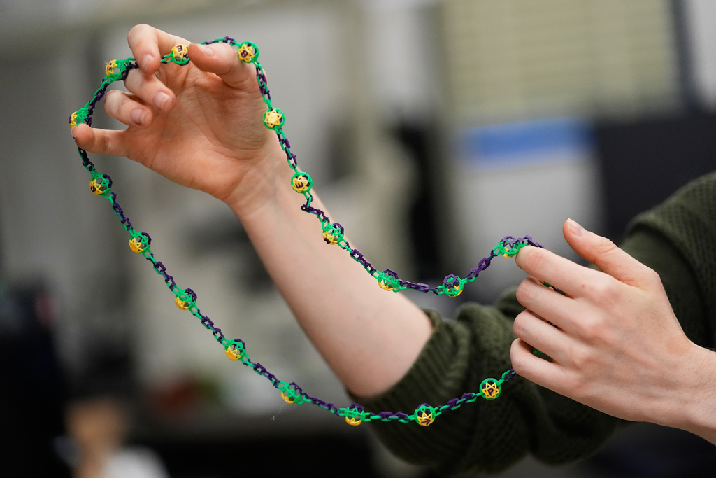 Alexis Strain, graduate student in biological sciences at Louisiana State University, shows the biodegradable Mardi Gras beads they are developing, Jan. 27, 2026, in Baton Rouge, La. (AP Photo/Gerald Herbert)