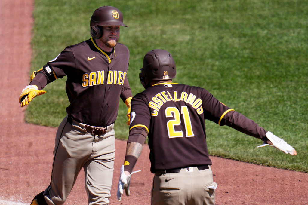 San Diego Padres' Jake Cronenworth, left, is greeted by Nick Castellanos (21) after hitting a two-run home run off Pittsburgh Pirates pitcher Justin Lawrence during the seventh inning of a baseball game in Pittsburgh, Wednesday, April 8, 2026. (AP Photo/Gene J. Puskar)