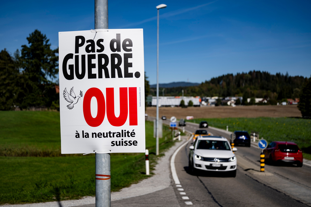 An electoral poster reads "No war, Yes to Swiss neutrality" is posted along a road in Epagny, Switzerland, Friday, Sept. 25, 2026. (Jean-Christophe Bott/Keystone via AP)