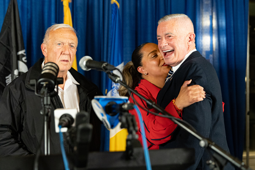Councilwoman At-Large candidate Jennise Sarmiento embraces Jersey City mayoral candidate Jim McGreevey at his election night party, Jersey City, Tuesday, Nov. 4, 2025, in Jersey City, N.J. (AP Photo/Stefan Jeremiah)