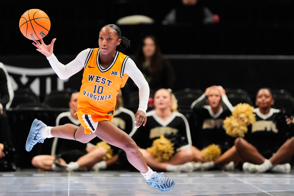 West Virginia's Jordan Harrison chases after the ball after knocking the ball away from Colorado's Jade Masogayo during second half of an NCAA college basketball game in the semifinals of the Big 12 Conference tournament Saturday, March 7, 2026, in Kansas City, Mo. (AP Photo/Charlie Riedel)