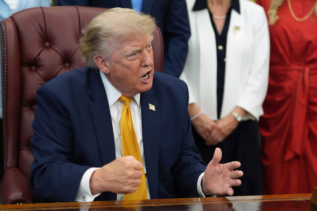 President Donald Trump gestures as he speaks during a meeting about military families, in the Oval Office of the White House, Monday, Aug. 3, 2026, in Washington. (AP Photo/Alex Brandon)