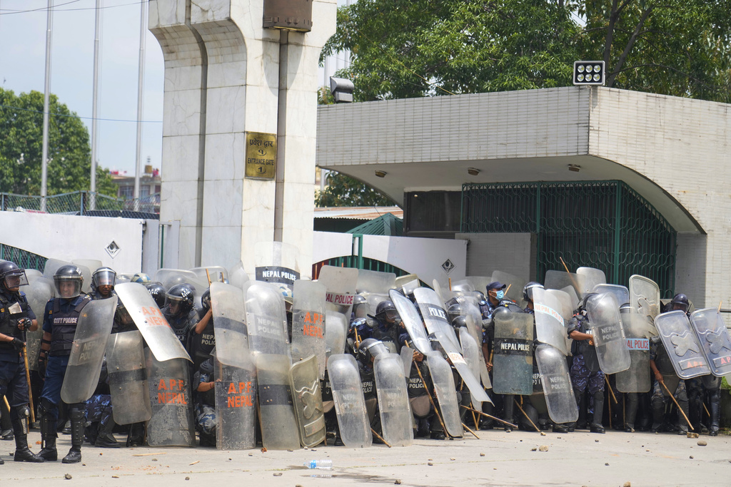 Riot police stand guard outside the Parliament building as they clash with the protesters in Kathmandu, Nepal, Monday, Sept. 8, 2025. (AP Photo/Niranjan Shrestha)