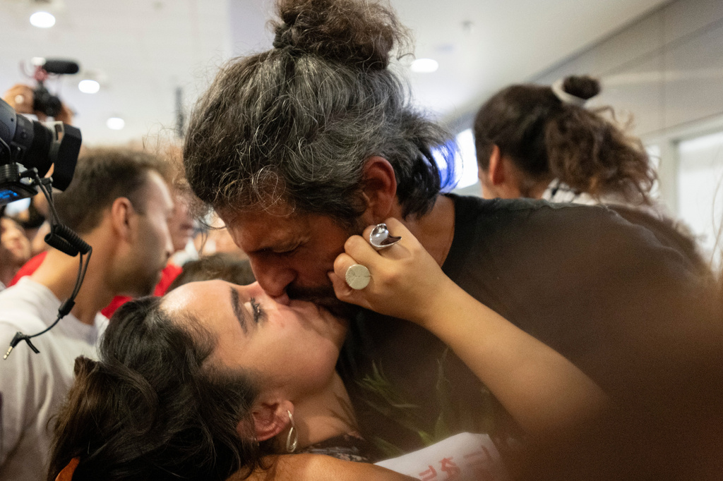 An activist from the Global Sumud Flotilla kisses a woman upon his arrival at Eleftherios Venizelos International Airport in Athens, Greece, Friday, May 22, 2026. (AP Photo/Michael Varaklas)