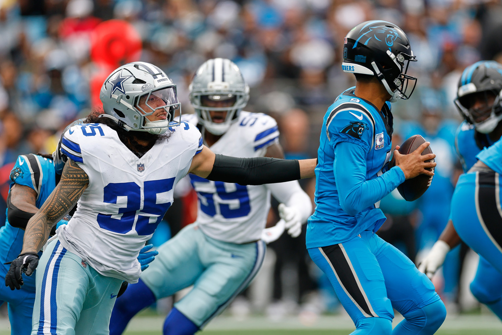 Dallas Cowboys linebacker Marist Liufau (35) sacks Carolina Panthers quarterback Bryce Young, right, in the second half of an NFL football game, Sunday, Oct. 12, 2025, in Charlotte, N.C. (AP Photo/Rusty Jones)