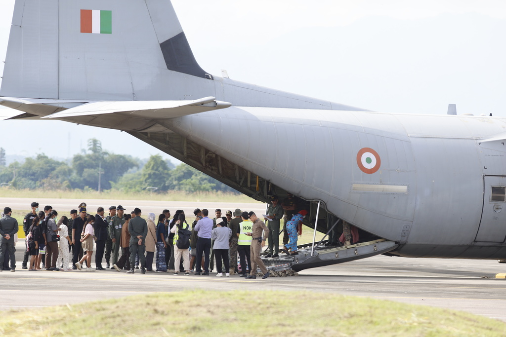 India nationals, believed to have worked at scam center in Myanmar, board a plane at Thailand's Mae Sot International Airport in Tak, before being sent back to India, Thursday, Nov. 6, 2025. (AP Photo/Sarot Meksophawannakul)