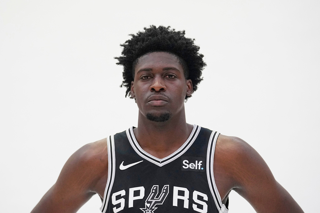 FILE - San Antonio Spurs center Charles Bediako poses for photos during an NBA basketball media day in San Antonio, Oct. 2, 2023. (AP Photo/Eric Gay, File)