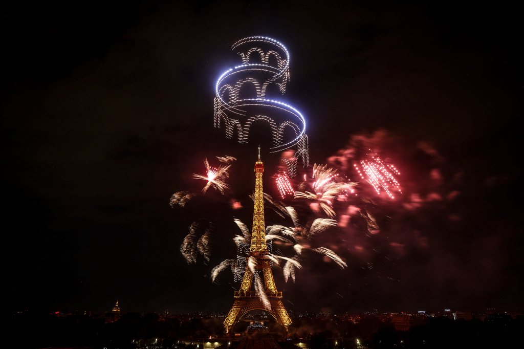 Fireworks and drones illuminate the Eiffel Tower in Paris, during the eve of Bastille Day celebrations late Monday, July 13, 2026. (AP Photo/Thomas Padilla)